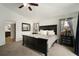 Comfortable main bedroom with a dark wood bed frame, cozy carpet, and ample natural light at 1126 Oxbow Rd, Wimauma, FL 33598