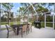 Enjoy the outdoors on this screened patio with dining set and grill, perfect for entertaining at 1126 Oxbow Rd, Wimauma, FL 33598