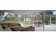 Spacious screened patio with outdoor furniture and barbecue grill at 1126 Oxbow Rd, Wimauma, FL 33598