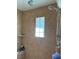 Tiled shower featuring dual shower heads, glass block window, and built-in niche at 1126 Oxbow Rd, Wimauma, FL 33598