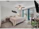 Bright bedroom with a ceiling fan, television and natural light at 11432 Freshwater Ridge Dr, Riverview, FL 33569