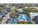 Aerial view of community amenities featuring a pool, shuffleboard courts, and well-maintained landscaping at 11485 Oakhurst Rd # 111, Largo, FL 33774