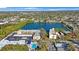 Aerial view of the building overlooking a lake, with a parking lot and a pool at 11485 Oakhurst Rd # 111, Largo, FL 33774