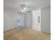 Spacious bedroom with neutral carpet, ceiling fan, and access to other rooms, offering a versatile living space at 11485 Oakhurst Rd # 111, Largo, FL 33774