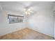 Neutral bedroom features ceiling fan and large window at 11485 Oakhurst Rd # 111, Largo, FL 33774