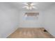 Neutral carpeted bedroom with a ceiling fan and a window, providing a comfortable and simple living space at 11485 Oakhurst Rd # 111, Largo, FL 33774