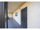 Exterior view of a unit entrance featuring a screen door, exterior window, and neutral colored wall at 11485 Oakhurst Rd # 111, Largo, FL 33774