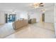 Comfortable living room featuring tile floors, a sliding glass door to a patio, and mirrored accent wall at 11485 Oakhurst Rd # 111, Largo, FL 33774