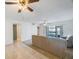Open living room featuring a ceiling fan, tiled floors, neutral walls, and sliding glass doors to a patio at 11485 Oakhurst Rd # 111, Largo, FL 33774
