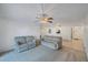 Open living room with ceiling fans, wall mirror and easy access to the front door at 11485 Oakhurst Rd # 111, Largo, FL 33774