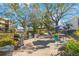 Community area with multiple grills and tables, perfect for outdoor dining and social gatherings in a landscaped setting at 11485 Oakhurst Rd # 111, Largo, FL 33774