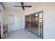 Enclosed patio with sliding glass doors and a ceiling fan, offering a seamless transition to indoor living space at 11485 Oakhurst Rd # 111, Largo, FL 33774