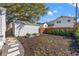 A well-maintained backyard with stepping stones, showcasing mulched garden beds and storage shed at 1205 13Th N St, St Petersburg, FL 33705