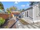 Backyard featuring professional landscaping with a stone pathway, grass and shrubs, and rear patio access at 1205 13Th N St, St Petersburg, FL 33705