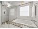 Bathroom featuring a soaking tub with a tiled wall, glass shower door, and granite counters at 1205 13Th N St, St Petersburg, FL 33705