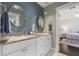 Bathroom featuring double sinks, marble countertops, and soft blue accent tile at 1205 13Th N St, St Petersburg, FL 33705