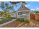A well kept home with a cozy front porch and manicured landscaping, framed by a classic picket fence at 1205 13Th N St, St Petersburg, FL 33705
