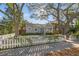 Charming home featuring a well-maintained front yard, picket fence, and inviting porch with blue front door at 1205 13Th N St, St Petersburg, FL 33705
