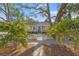 A charming home featuring a well-manicured lawn, a classic white picket fence, and a vibrant blue front door at 1205 13Th N St, St Petersburg, FL 33705