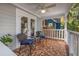 Cozy front porch with mosaic-tile flooring, ceiling fan, and comfortable seating at 1205 13Th N St, St Petersburg, FL 33705