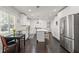 Bright open kitchen with stainless steel appliances, island, and adjacent breakfast nook with stainless steel refrigerator at 1205 13Th N St, St Petersburg, FL 33705