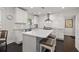 This bright kitchen features a central island with a white countertop and bar stool seating at 1205 13Th N St, St Petersburg, FL 33705