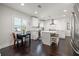 Bright kitchen features white cabinetry, stainless steel appliances, central island, and adjacent breakfast nook at 1205 13Th N St, St Petersburg, FL 33705