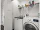 Bright laundry room with modern washer and dryer, complemented by wire shelving for organized storage at 1205 13Th N St, St Petersburg, FL 33705