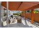 Charming covered outdoor patio with comfortable seating, lush landscaping, and a built-in grill at 1205 13Th N St, St Petersburg, FL 33705