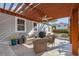 Charming covered outdoor patio with comfortable seating, lush landscaping, and a built-in grill at 1205 13Th N St, St Petersburg, FL 33705