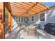 Charming covered outdoor patio with comfortable seating, lush landscaping, and a built-in grill at 1205 13Th N St, St Petersburg, FL 33705