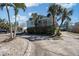 A bright blue coastal home with a spacious driveway and lush tropical landscaping at 1213 1St St, Indian Rocks Beach, FL 33785