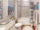 Well-lit bathroom featuring a granite vanity top, white cabinets, and a shower-tub combination at 12403 Brick Cobblestone Dr, Riverview, FL 33579