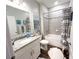 Stylish bathroom featuring granite vanity top, white cabinets, and a shower-tub combination at 12403 Brick Cobblestone Dr, Riverview, FL 33579