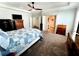 Spacious bedroom with a large bed, a safe, and neutral colored carpet at 12403 Brick Cobblestone Dr, Riverview, FL 33579
