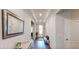Bright entryway with tray ceiling, hardwood floors, and a decorative mirror at 12403 Brick Cobblestone Dr, Riverview, FL 33579
