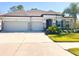 Charming one-story home featuring a three-car garage and beautifully landscaped front yard at 12403 Brick Cobblestone Dr, Riverview, FL 33579