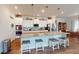 Kitchen featuring white cabinets, stainless steel appliances, an island with bar seating, and granite countertops at 12403 Brick Cobblestone Dr, Riverview, FL 33579