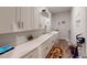 Bright laundry room with modern appliances, ample counter space, and storage cabinets at 12403 Brick Cobblestone Dr, Riverview, FL 33579