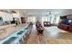 Open-concept floor plan showcasing the kitchen, dining, and living areas with hardwood floors at 12403 Brick Cobblestone Dr, Riverview, FL 33579