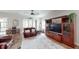 Bright living room with a ceiling fan, and a large built-in entertainment center at 12403 Brick Cobblestone Dr, Riverview, FL 33579
