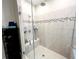 Walk-in shower featuring glass doors, tiled walls, and double shower heads at 12403 Brick Cobblestone Dr, Riverview, FL 33579