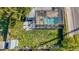 Overhead view of the backyard with screened pool, firepit area, shed, and lush lawn at 1319 Saddle Ct, Palm Harbor, FL 34683