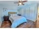 Inviting bedroom with a ceiling fan, wood-look floors, and a cozy atmosphere at 1319 Saddle Ct, Palm Harbor, FL 34683