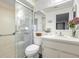 Bathroom with a glass-enclosed shower, single sink, and updated fixtures at 1368 Noell Blvd, Palm Harbor, FL 34683