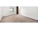 A bedroom has neutral carpet and trim, one window and a bi-fold closet at 1368 Noell Blvd, Palm Harbor, FL 34683