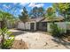 Charming home exterior featuring a spacious driveway, mature trees, and a well-maintained lawn at 1368 Noell Blvd, Palm Harbor, FL 34683