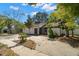 Charming home exterior featuring a spacious driveway, mature trees, and a well-maintained lawn at 1368 Noell Blvd, Palm Harbor, FL 34683