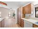 Bright kitchen featuring wood cabinets, light countertops, and views to the living area at 1368 Noell Blvd, Palm Harbor, FL 34683