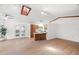 Bright living space featuring wood floors, skylight, and seamless flow to the kitchen area at 1368 Noell Blvd, Palm Harbor, FL 34683